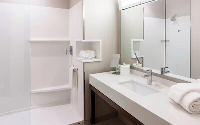 Modern accessible bathroom with walk-in shower at Courtyard By Marriott Houston North/Shenandoah.