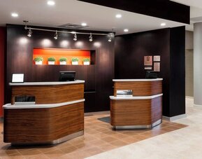Reception desk and lobby area at Courtyard By Marriott Houston North/Shenandoah.