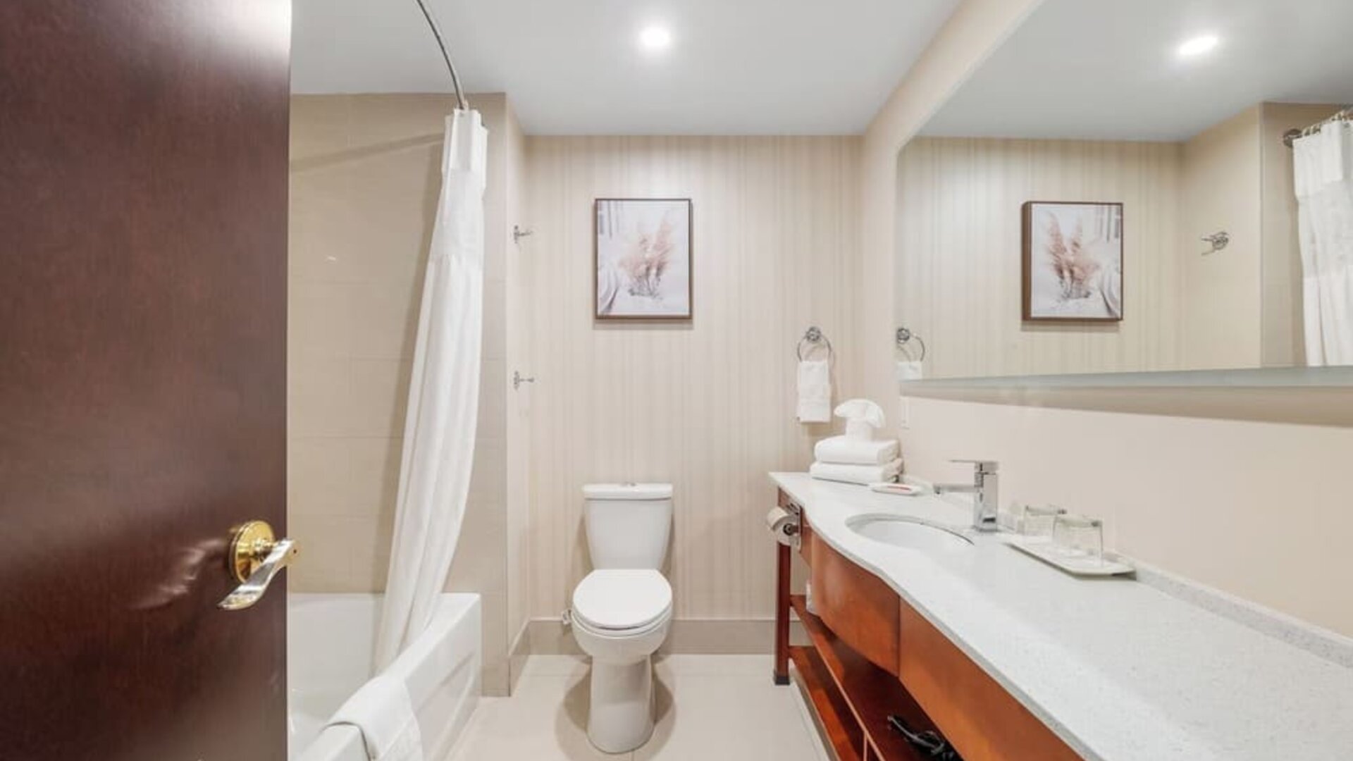 Modern bathroom with large vanity and bathtub at Hotel Montreal Metropolitan, An Ascend Collection Hotel.