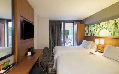 Modern guest room with two double beds and private balcony at Hilton Garden Inn New York Central Park South-Midtown West.