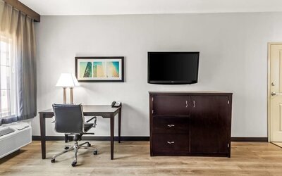In-room workspace with desk and television at La Quinta Inn & Suites By Wyndham Houston Energy Corridor.