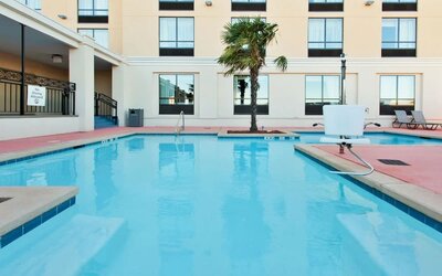Outdoor pool area with lounge seating at Holiday Inn Downtown Shreveport.