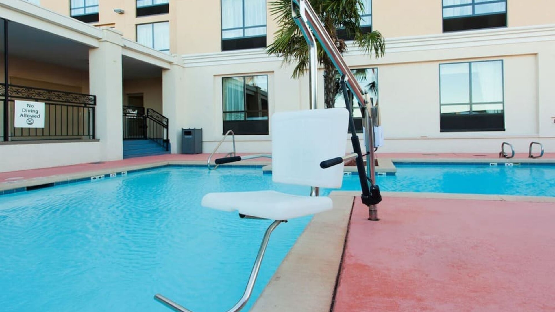 Outdoor swimming pool with accessibility lift at Holiday Inn Downtown Shreveport.