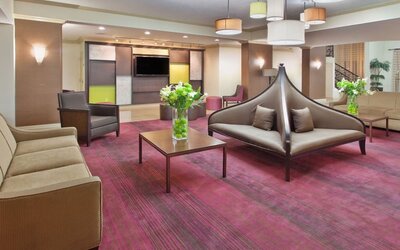 Modern hotel lobby seating area with contemporary furnishings at Holiday Inn Downtown Shreveport.