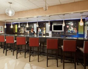 Hotel bar and lounge area with high-top seating at Holiday Inn Downtown Shreveport.