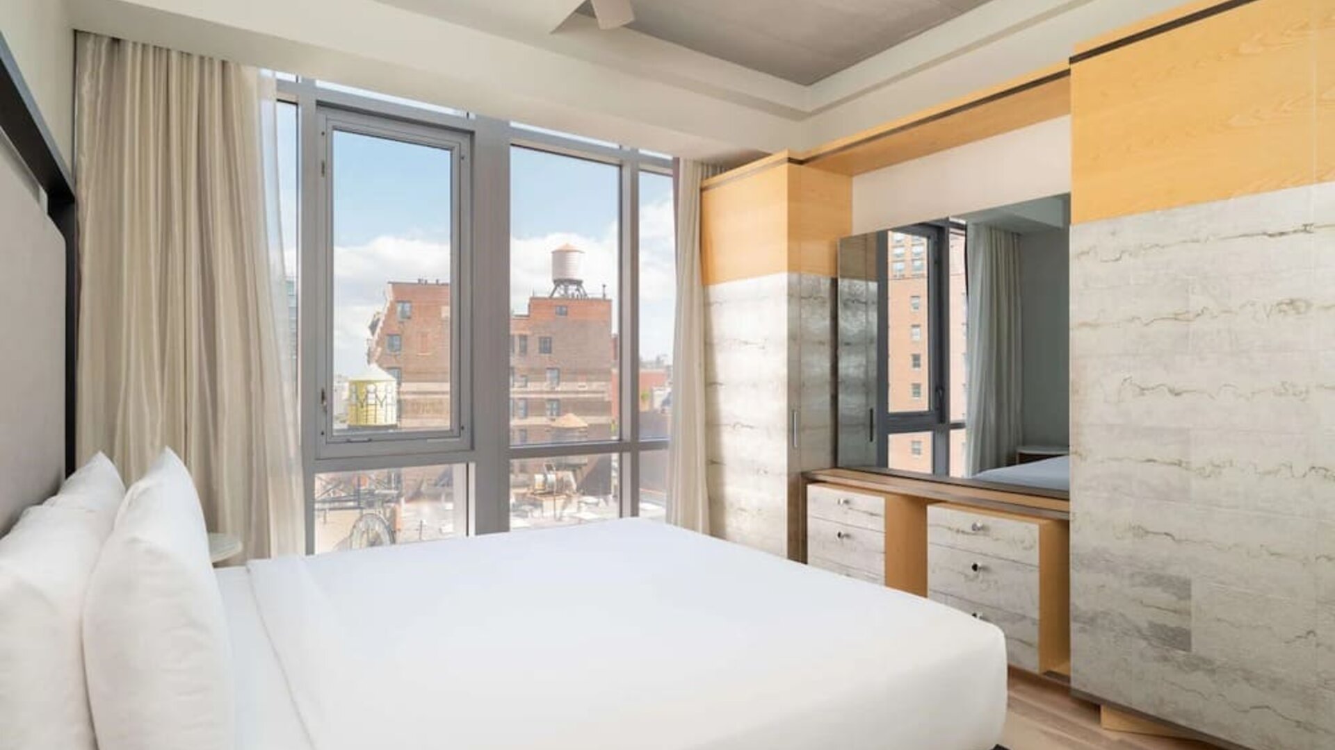 Bright guest room with floor-to-ceiling windows and modern furnishings at Hyatt Union Square New York.
