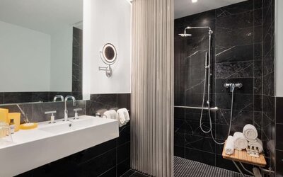 Luxury bathroom with walk-in rainfall shower and marble finishes at Hyatt Union Square New York.