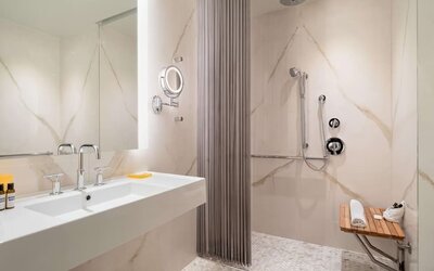 Modern marble bathroom with accessible walk-in shower at Hyatt Union Square New York.