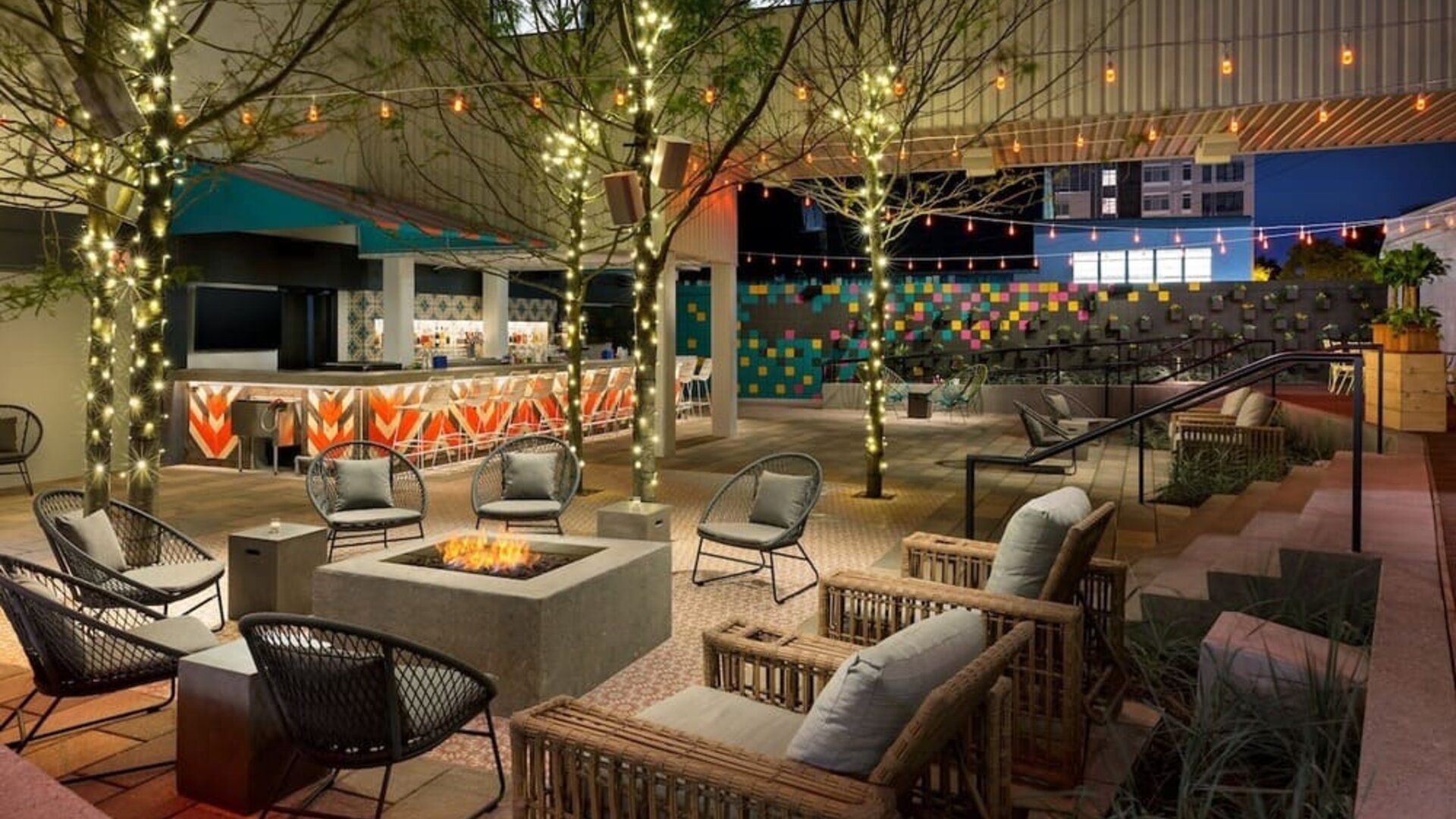 Outdoor patio lounge with fire pit and ambient lighting at Hotel Studio Allston.