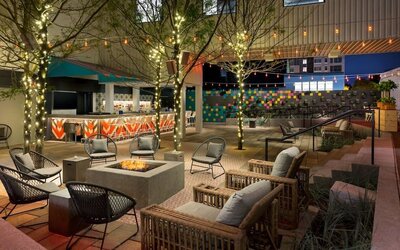 Outdoor patio lounge with fire pit and ambient lighting at Hotel Studio Allston.