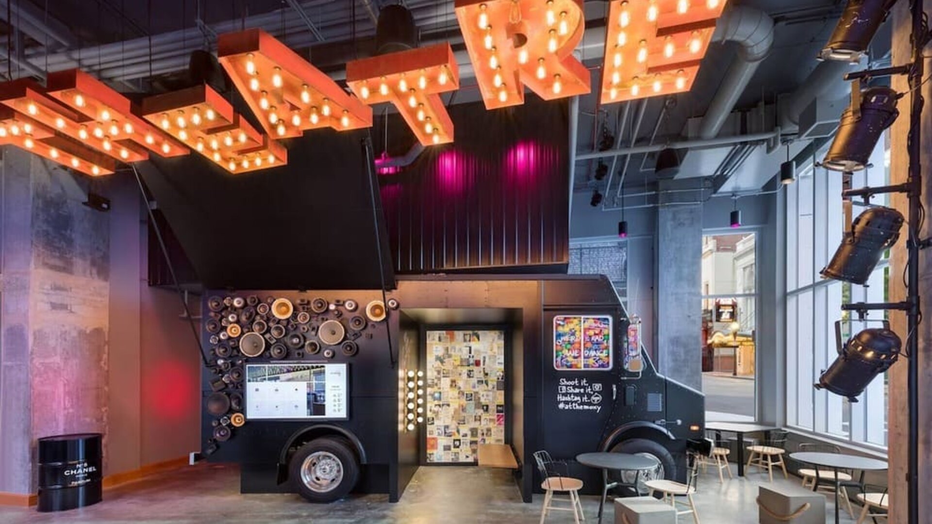 Colorful lobby lounge with neon ceiling lights and floor-to-ceiling windows at Moxy Boston Downtown.