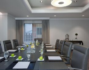 Executive boardroom with conference table setup, leather chairs, and natural lighting at Hyatt Regency Boston.