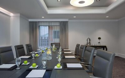 Executive boardroom with conference table setup, leather chairs, and natural lighting at Hyatt Regency Boston.