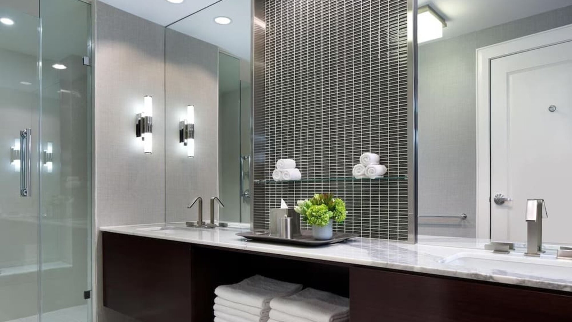 Modern hotel bathroom with marble vanity, glass walk-in shower, and contemporary lighting at Hyatt Regency Boston.