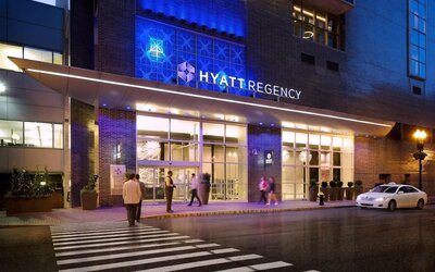 Exterior entrance view of Hyatt Regency Boston illuminated at night.
