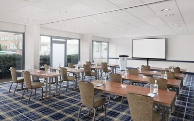 Bright meeting and conference room with classroom-style setup and presentation screen at Hyatt Regency Boston/Cambridge.