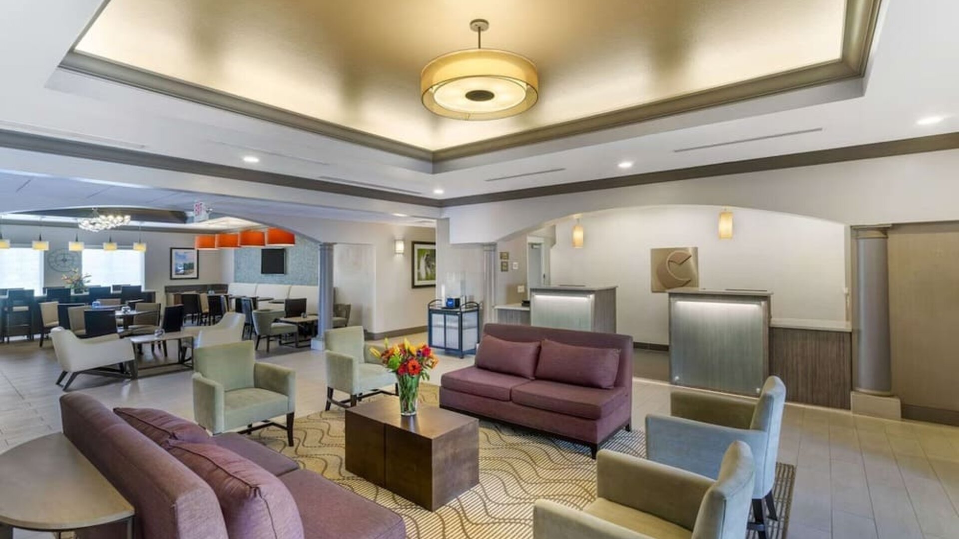 Spacious hotel lobby with comfortable seating, reception area, and modern lighting at Comfort Inn & Suites Port Charlotte-Punta Gorda.