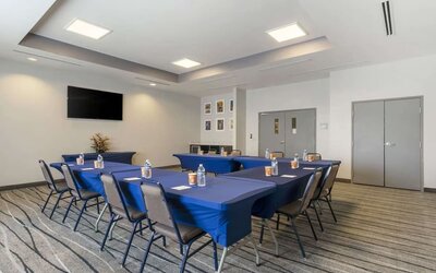 Meeting room with conference-style setup, presentation screen, and flexible event space at Comfort Inn & Suites Port Charlotte-Punta Gorda.
