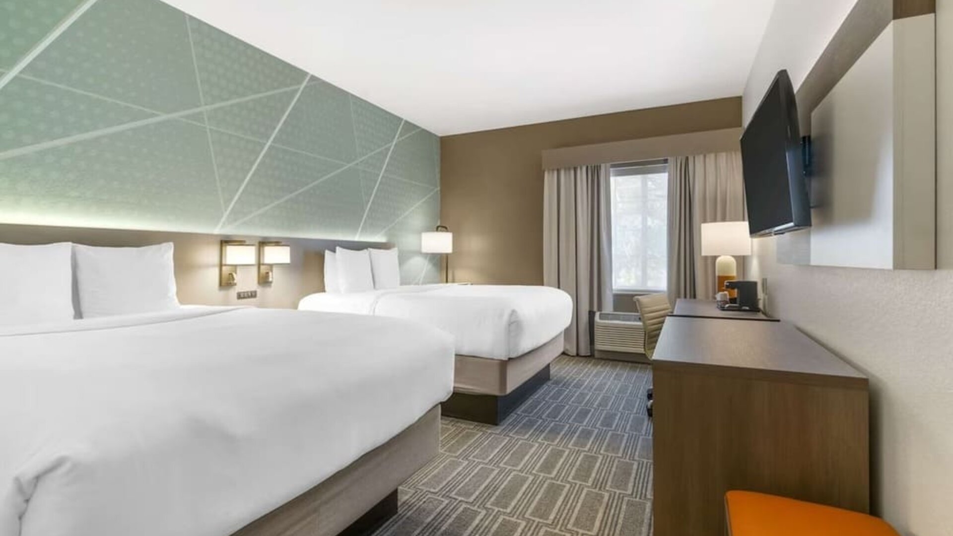 Double queen guest room with modern furnishings and spacious layout at Comfort Inn & Suites Port Charlotte-Punta Gorda.