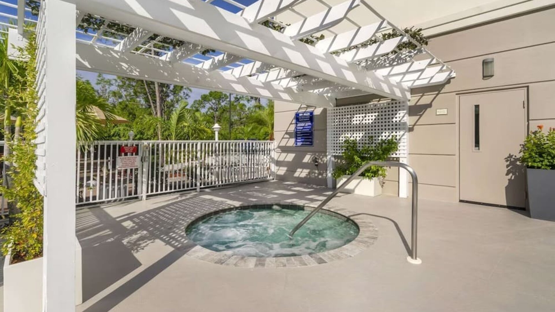Outdoor hot tub beneath a shaded pergola at Comfort Inn & Suites Port Charlotte-Punta Gorda.