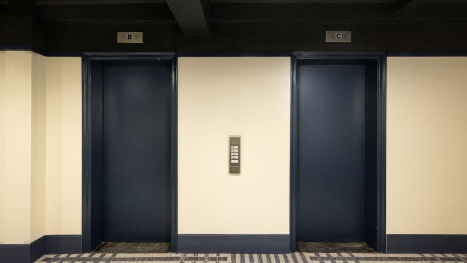 Elevator lobby with dark modern accents and contemporary design elements at Row NYC.