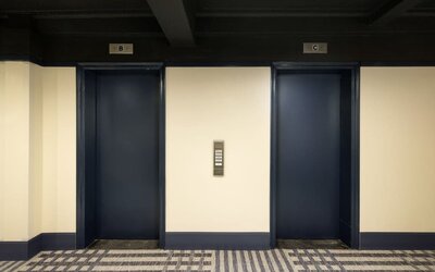 Elevator lobby with dark modern accents and contemporary design elements at Row NYC.