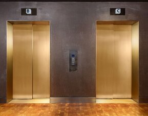 Contemporary elevator area with metallic finishes and upscale urban design at Row NYC.