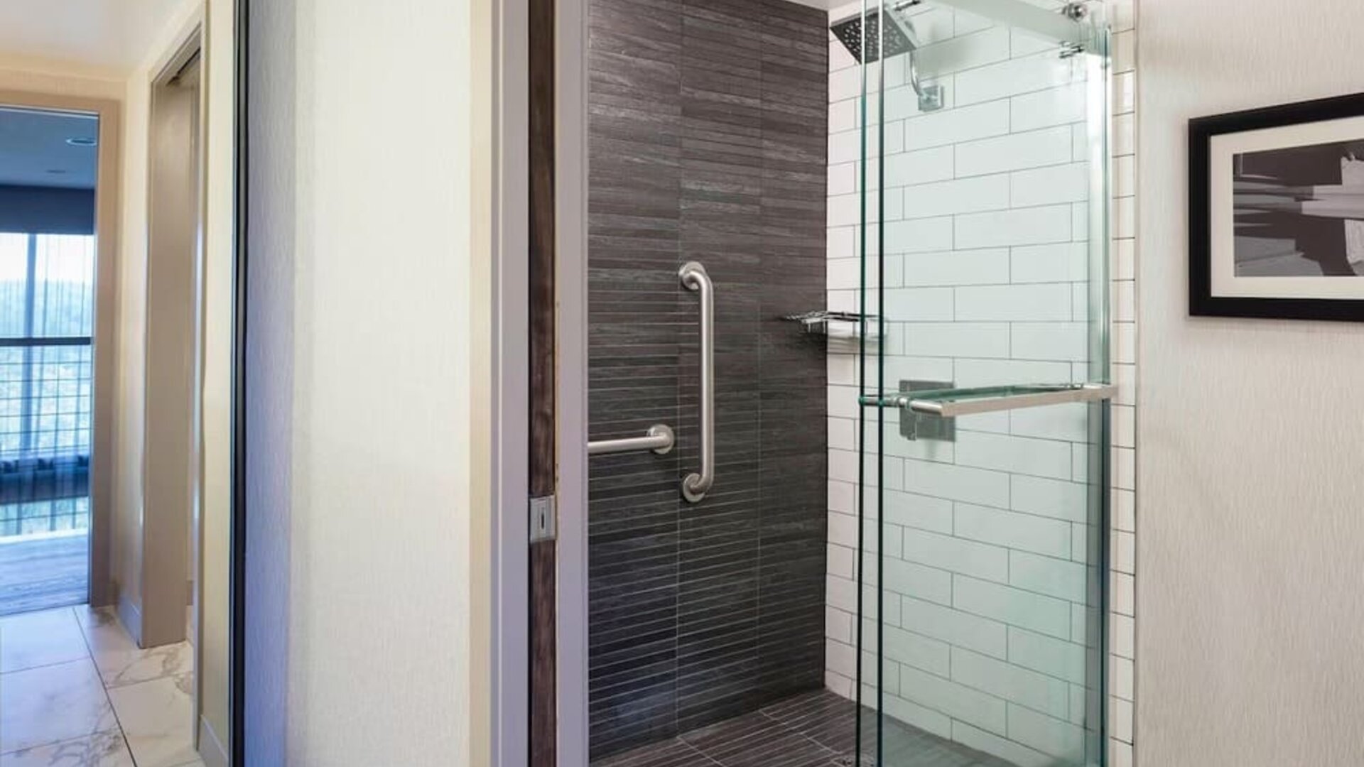 Modern glass-enclosed shower area with sleek tilework and contemporary bathroom design at Boston Marriott Newton.