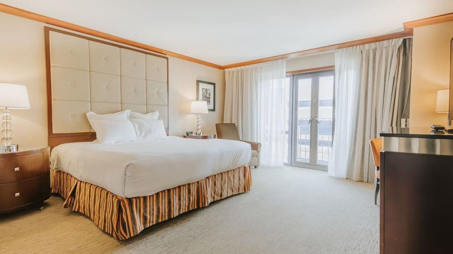 Bright king guest room featuring elegant décor, soft natural lighting, and contemporary furnishings at The Bostonian Boston, A Millennium Hotel.