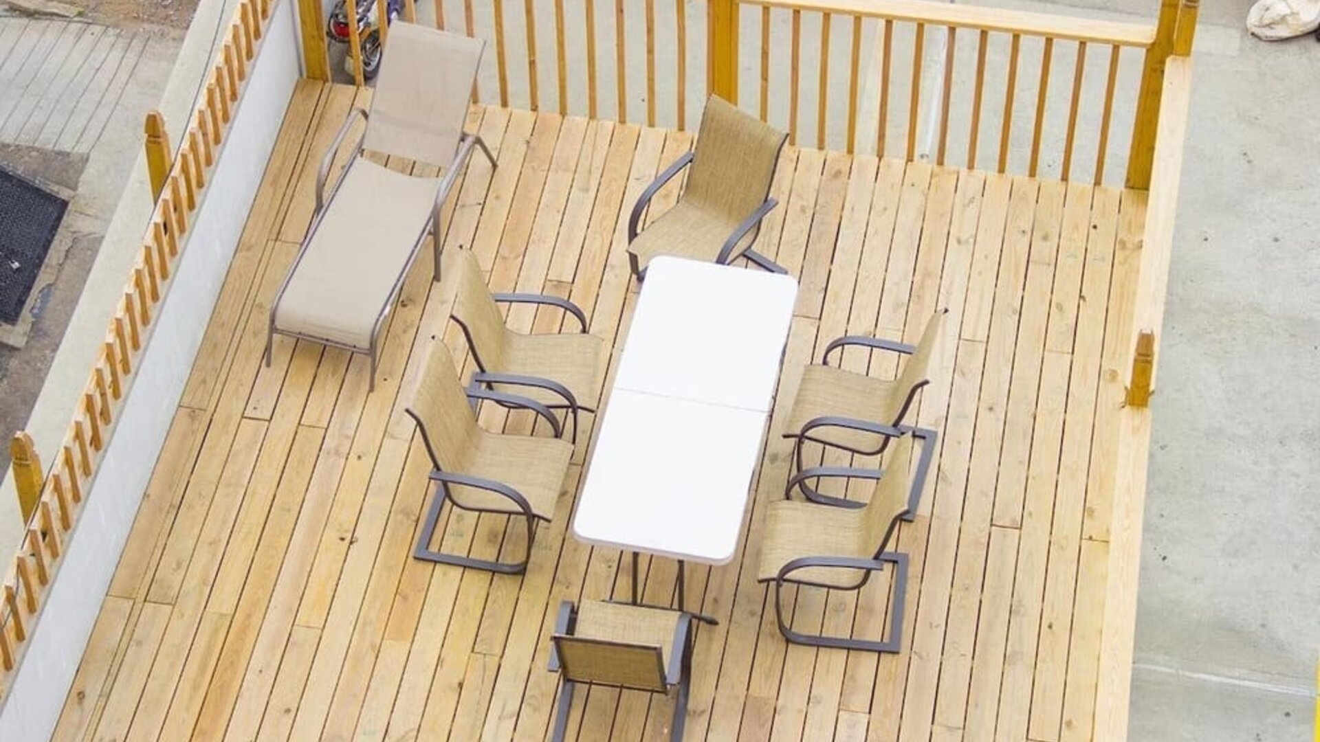 Outdoor seating deck with lounge chairs and dining table available for guests at Phoenix Hotel Brooklyn Sunset Park.