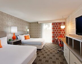Modern double-bed guest room offering comfortable accommodations, workspace amenities, and contemporary décor at The Garland.