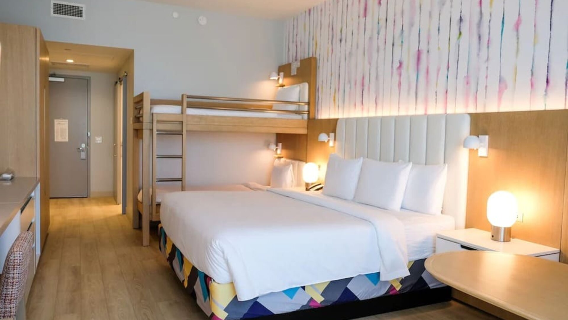 Family-friendly guest room featuring a king bed and built-in bunk beds, providing additional sleeping space for families traveling together.