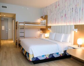 Family-friendly guest room featuring a king bed and built-in bunk beds, providing additional sleeping space for families traveling together.