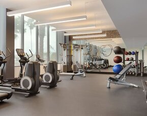 Fully equipped fitness center offering cardio machines, free weights, and strength-training equipment for guests maintaining their workout routines.