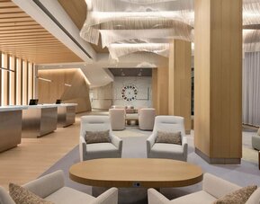Sophisticated indoor lounge and reception area with contemporary furnishings, soft lighting, and open communal spaces.